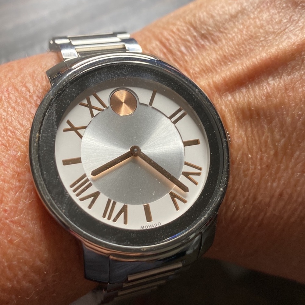 Ladies stainless steel Movado BOLD watch With rose gold numbers.